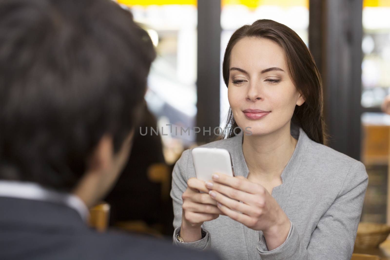 Couple in restaurant breakfasted, woman is on the phone, sms, su by LDProd