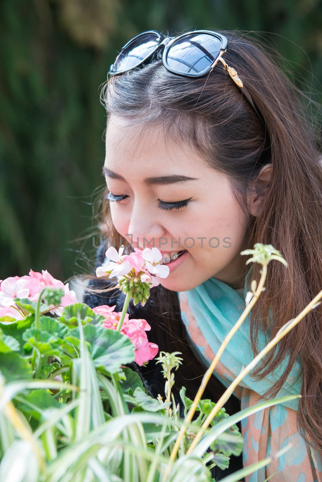 A portrait of beautiful asian woman with flower by jakgree