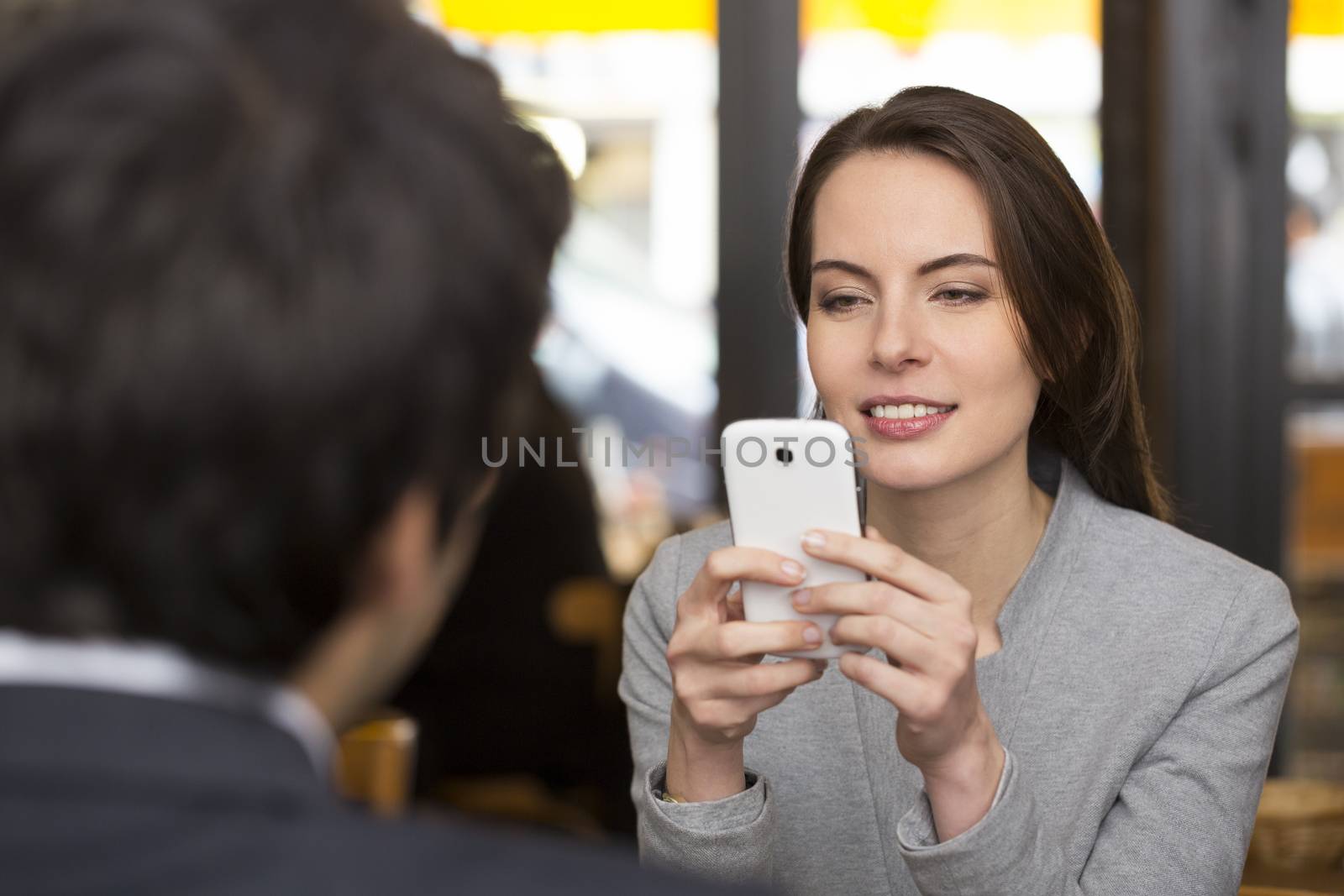 Couple in restaurant breakfasted, woman is on the phone, sms, su by LDProd