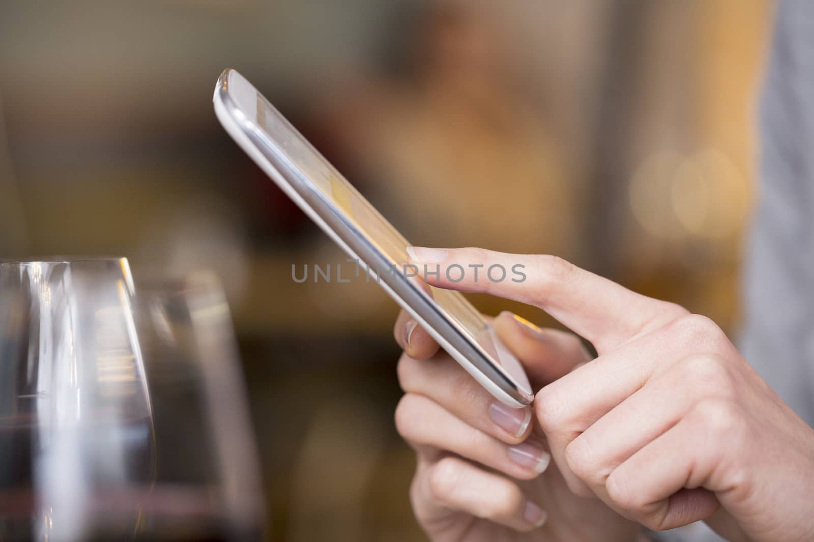 Close up of hands woman using her cell phone in restaurant, coff by LDProd