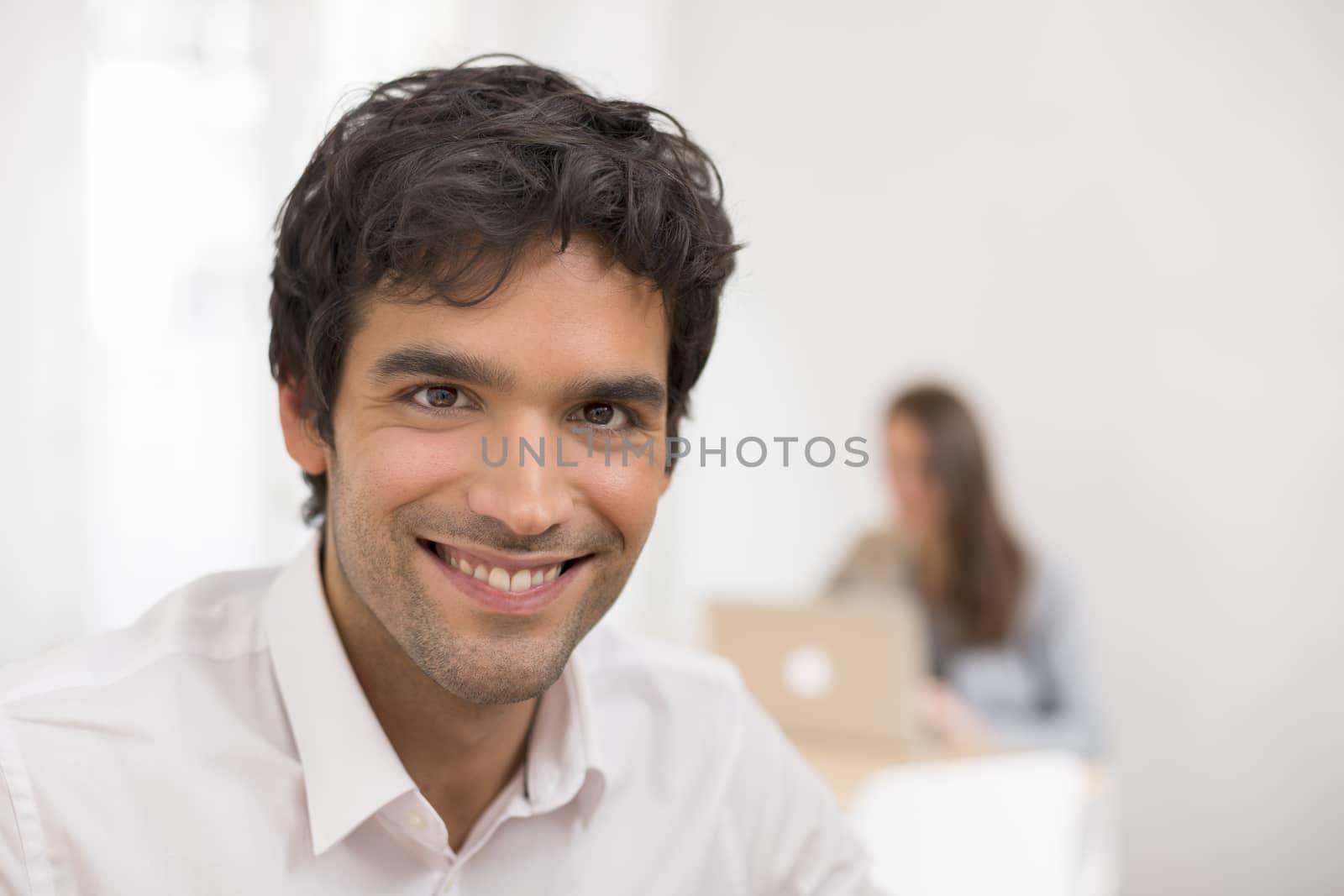 Portrait of businessman working on computer in office, looking c by LDProd