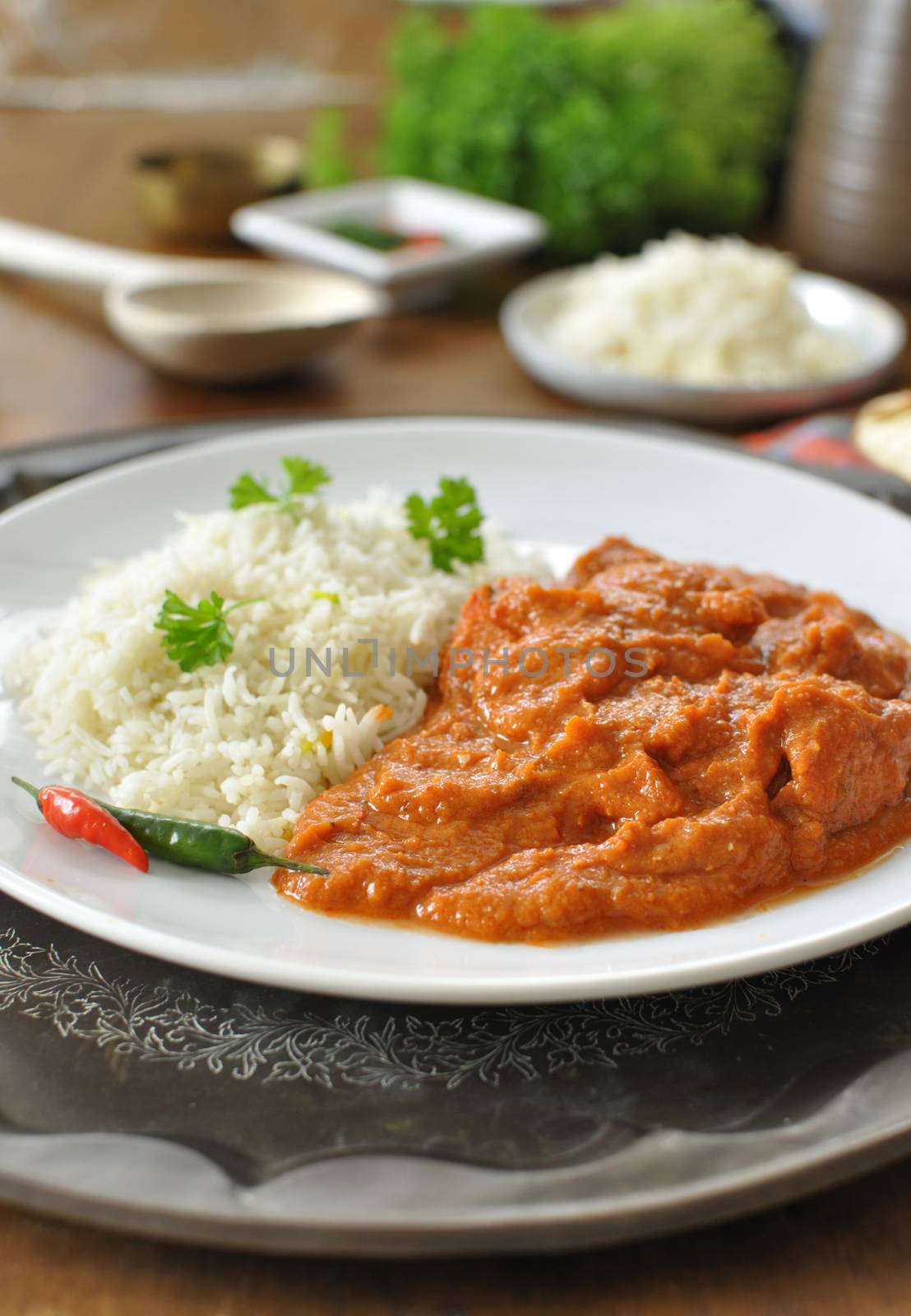 Chicken curry on a plate with rice an chilli pepper 