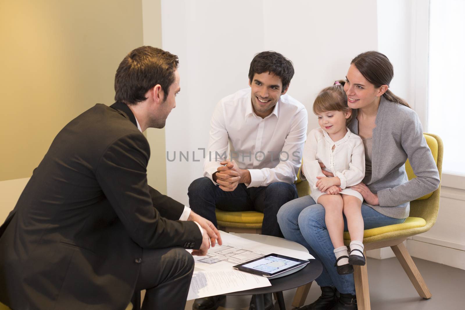 Young Family meeting real-estate agent to buy property by LDProd