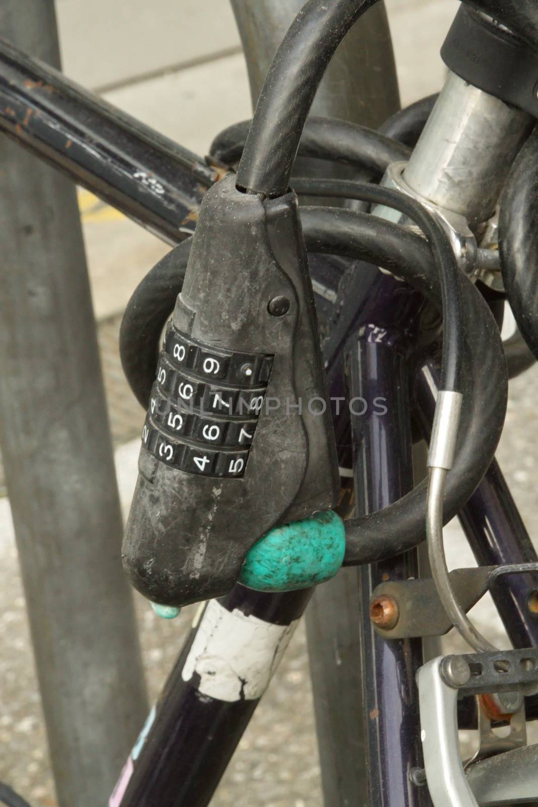 Close up on an old closed city bike padlock with numbers