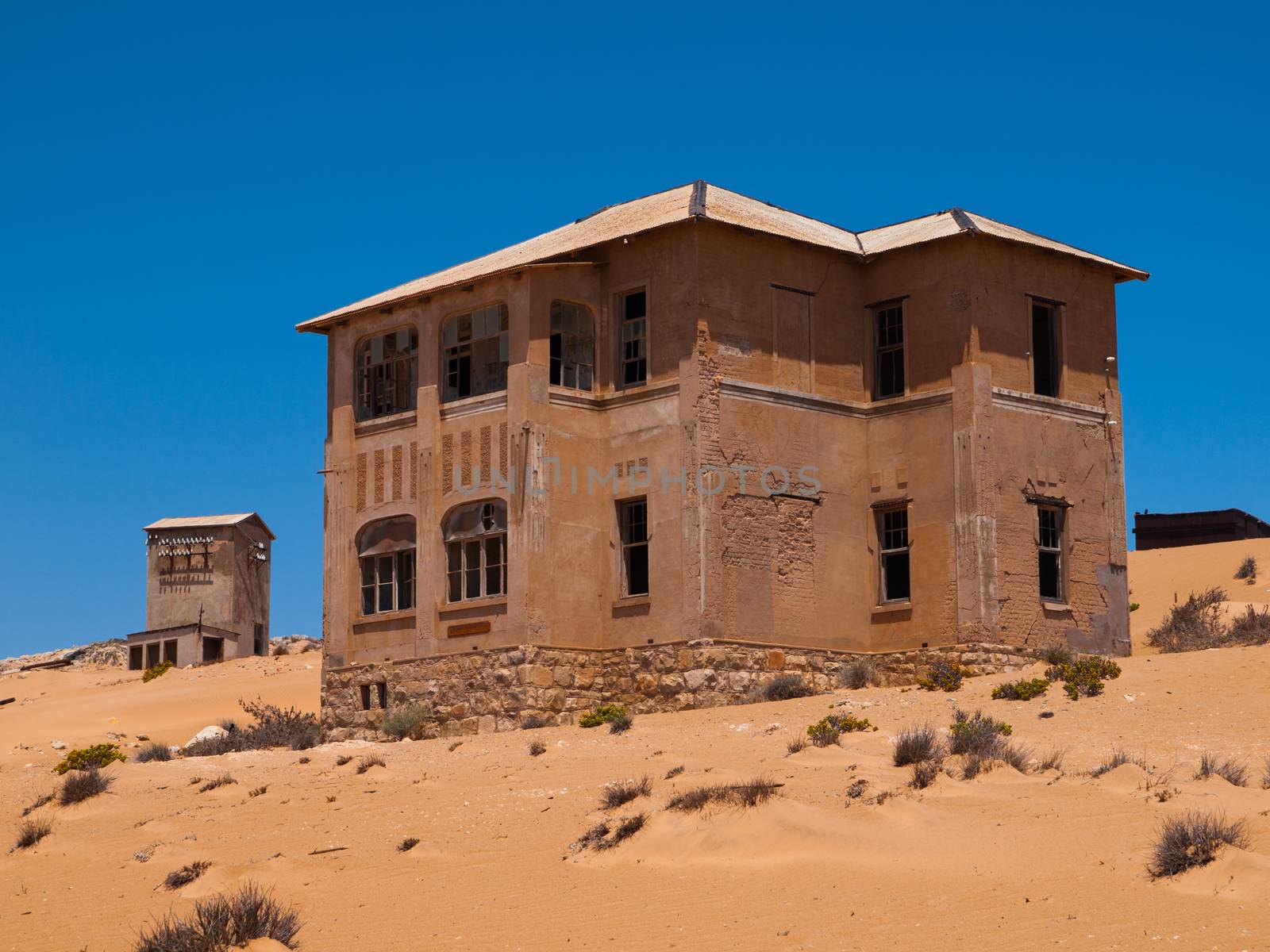 Abandoned house in Kolmanskop ghost village Sand in abandoned house in Kolmanskop ghost town by pyty