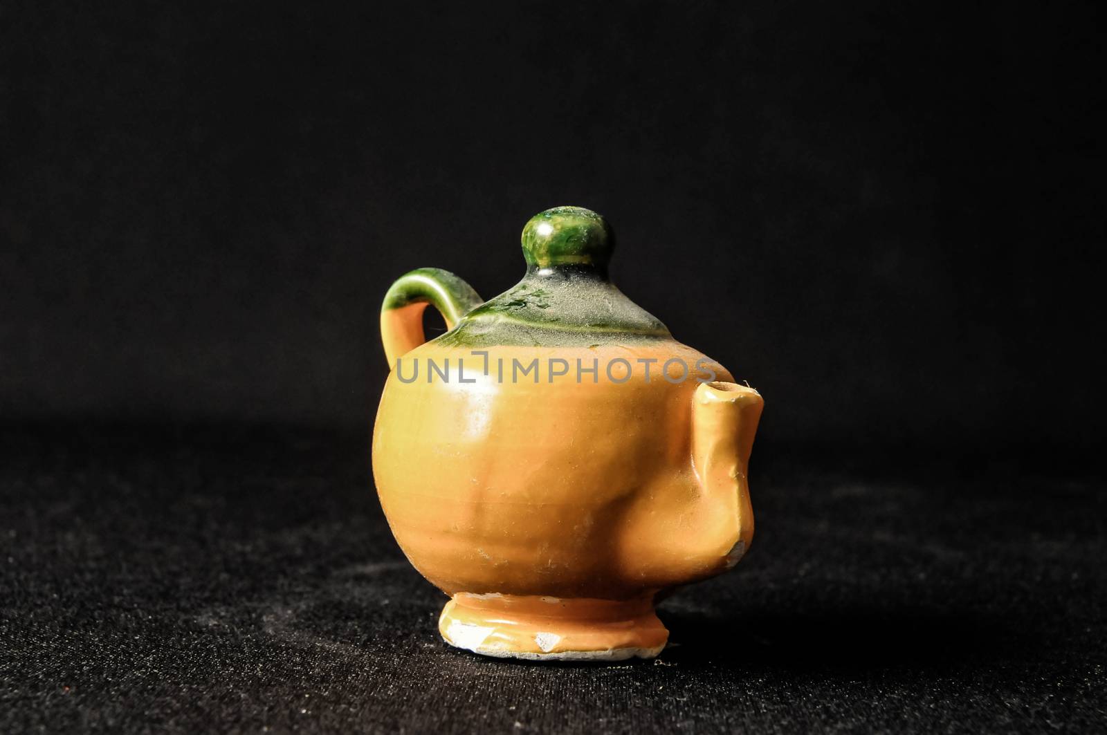 Colorful designed clay vase over a Black background