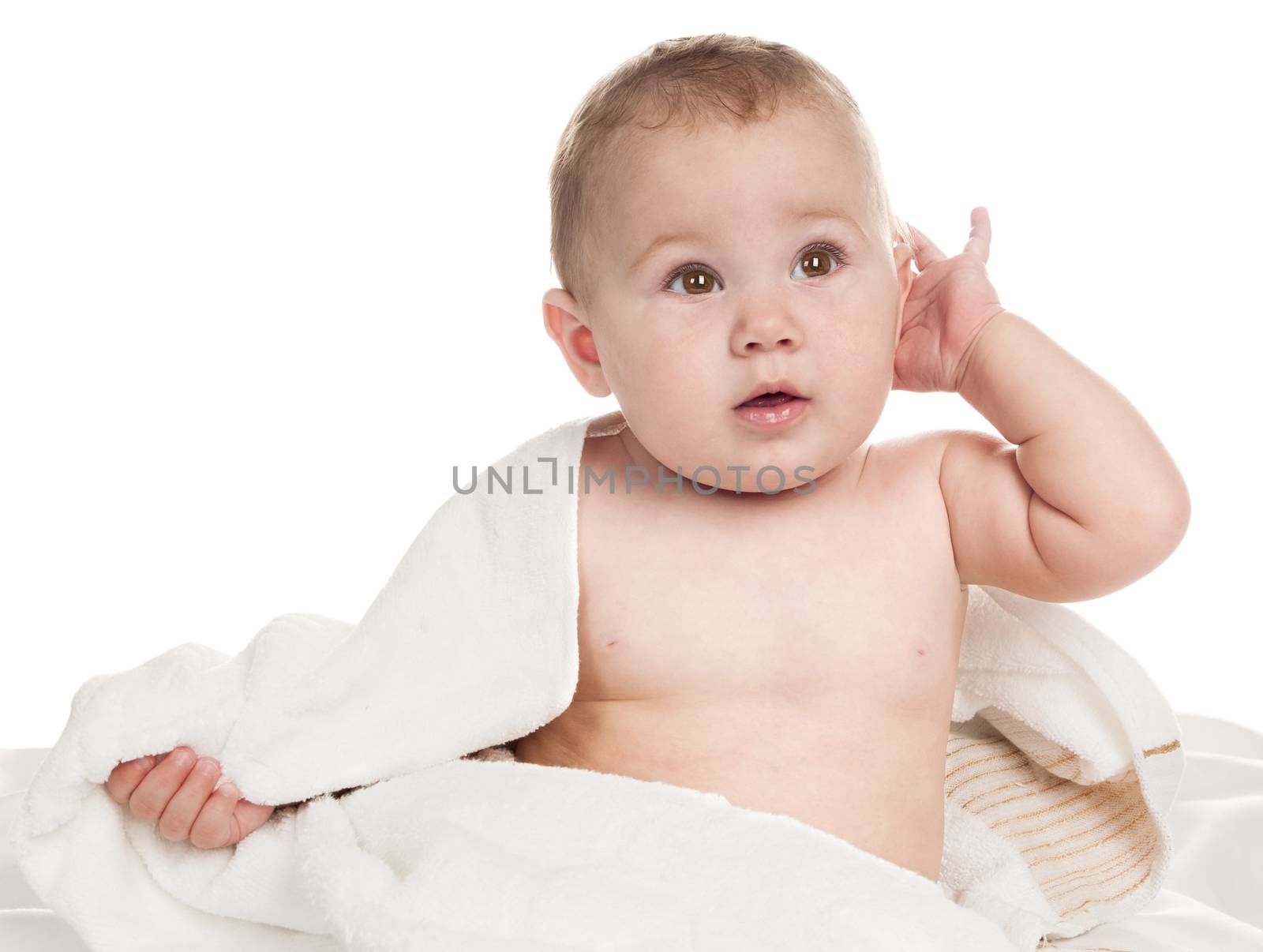 Beautiful child sitting wrapped in towel. Isolated on white background