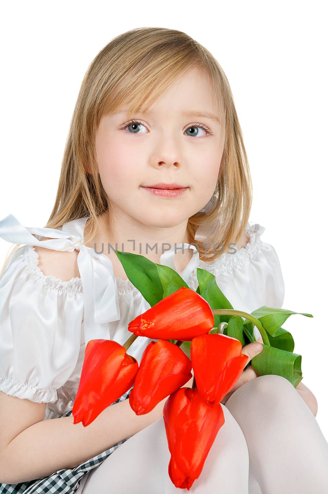 little girl with bunch of red tulips