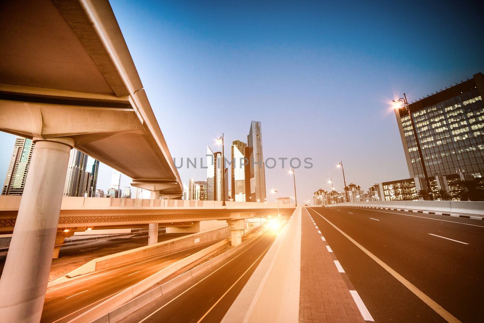evening landscape of a modern city with bridges, roads and skyscrapers