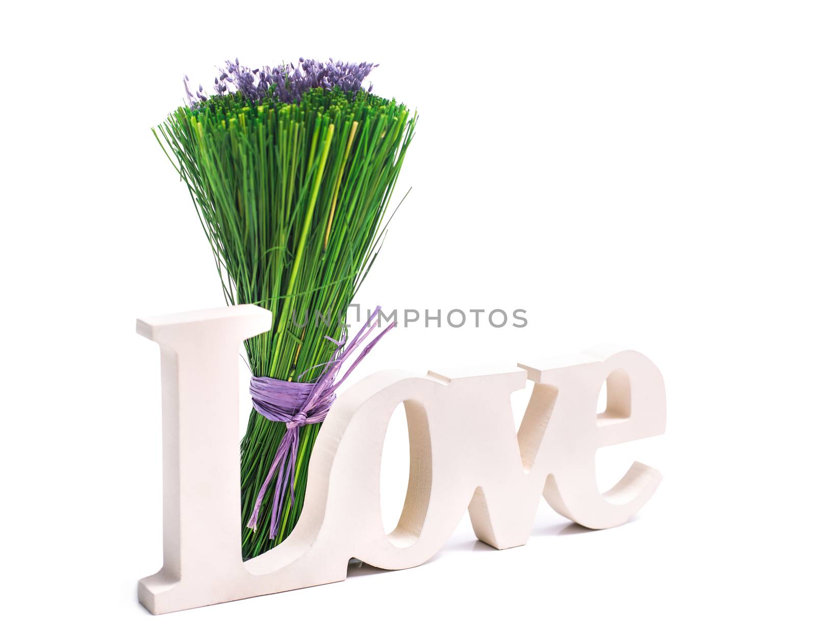 Sign of love with a bunch of green grass with purple flowers. Isolated on white