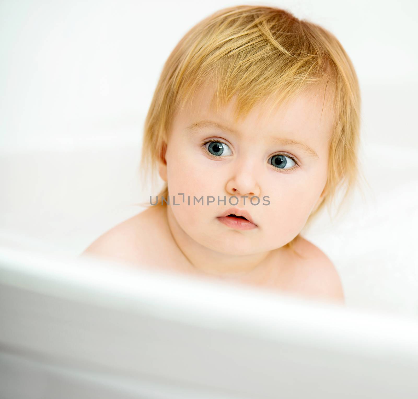 little baby sitting in the bath