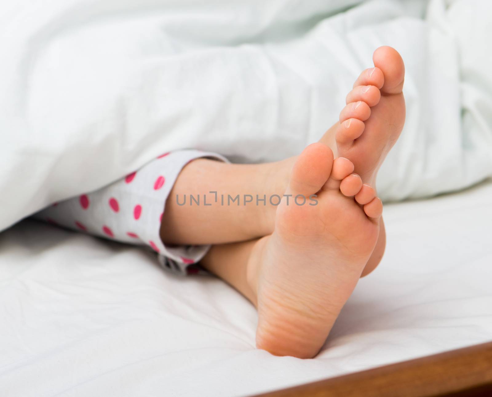 Baby bare feet on the bed by GekaSkr