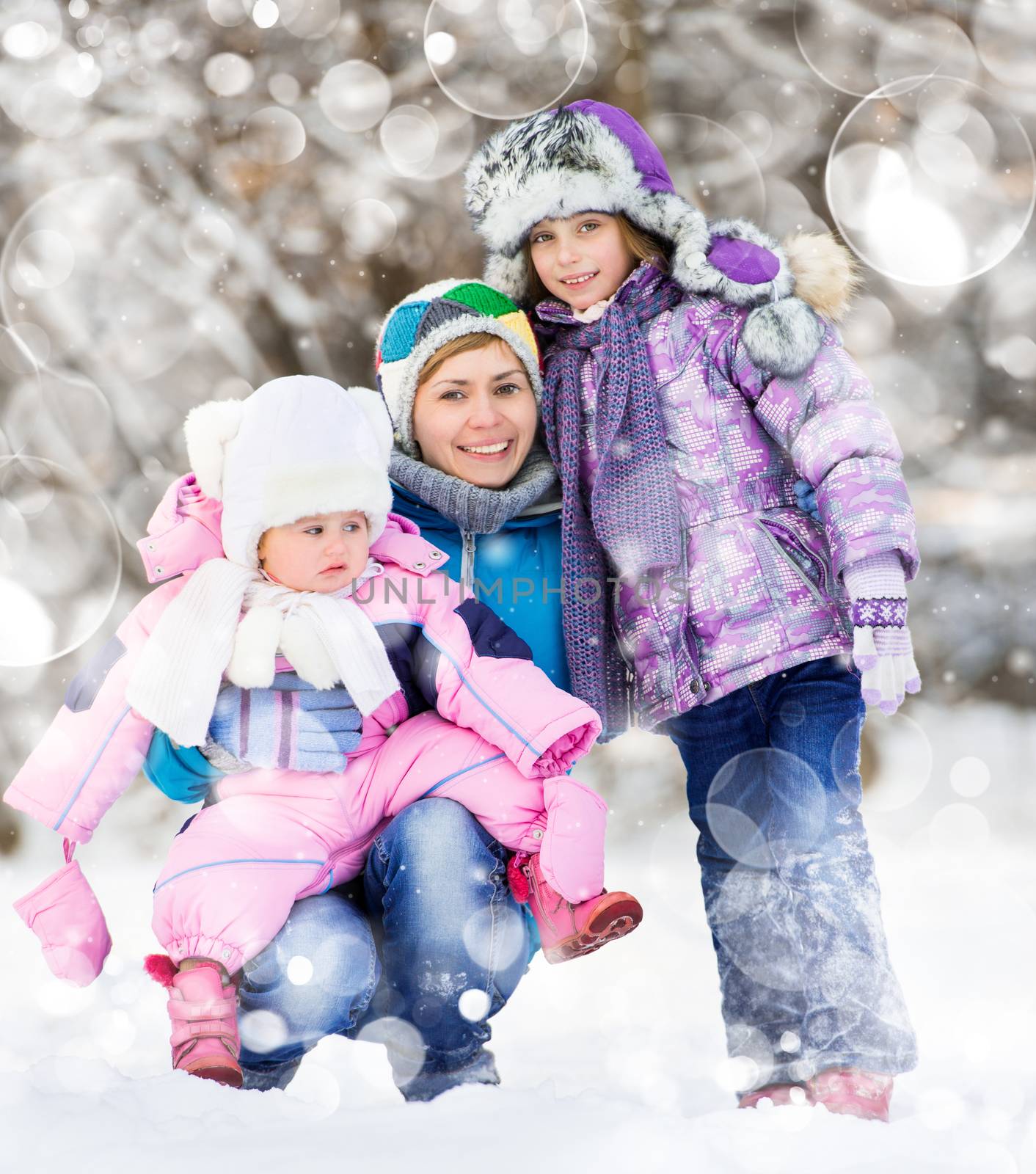 Happy mother with two kids on a winter walk