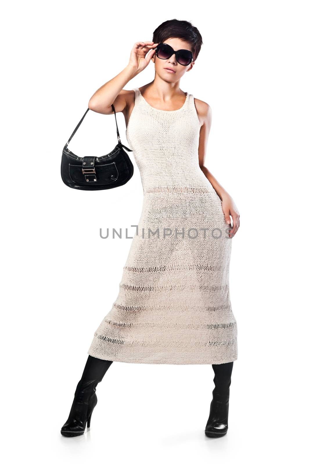 Fashion girl in a beautiful dress in the studio on a gray background