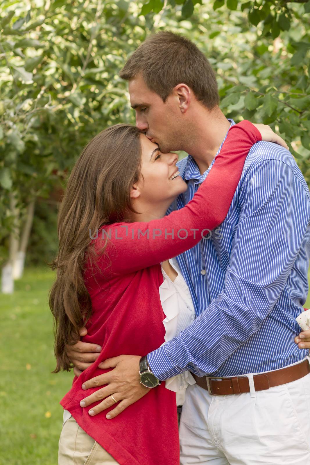 Beautiful embraced couple in the park by manaemedia