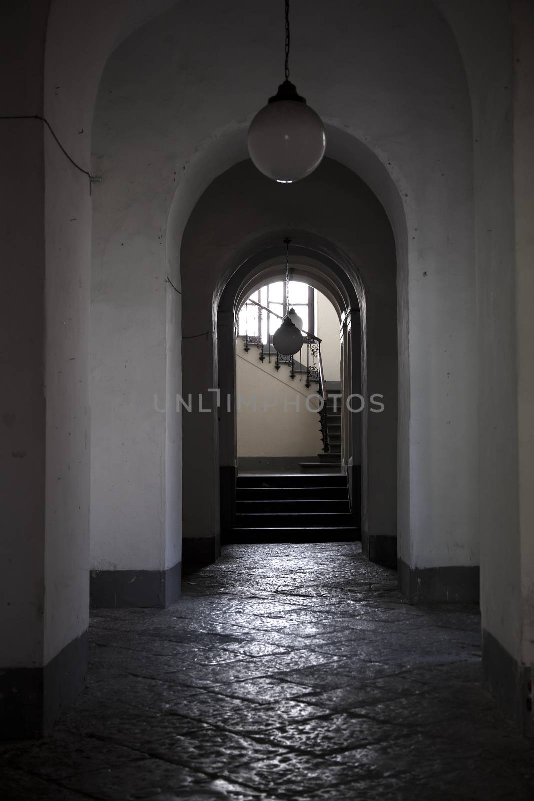 Old home doorway with stairs, shadow and white wall. architectural detail