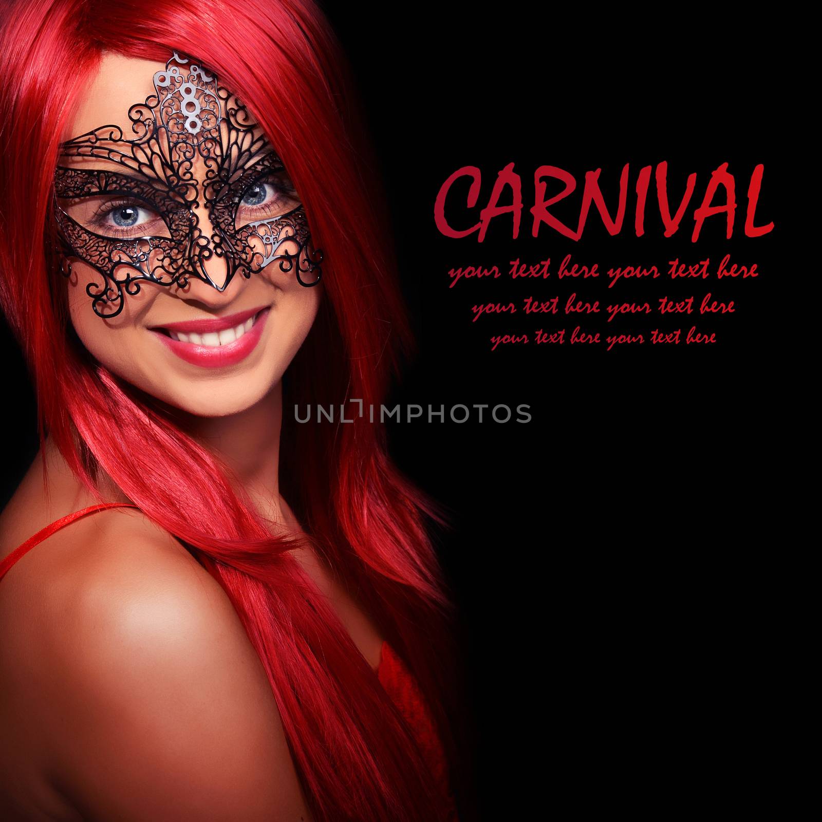 Beautiful red haired woman in carnival mask over black background