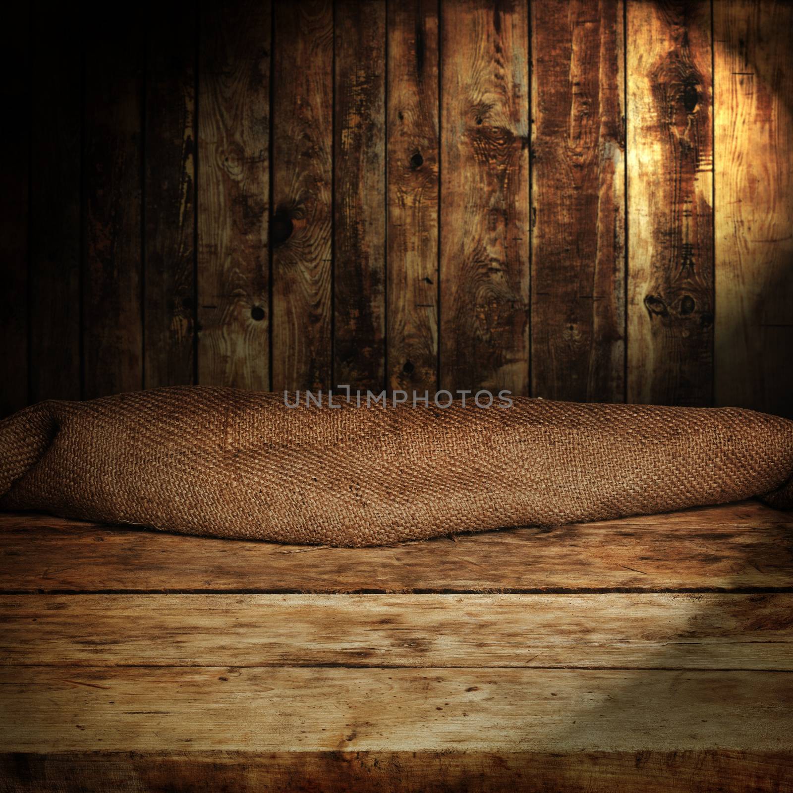 Empty wooden table and dark brown wall in background