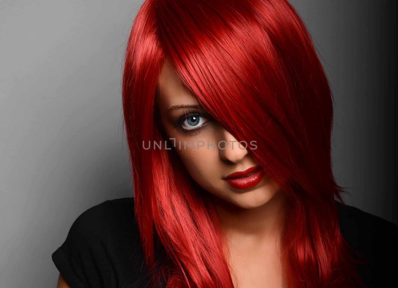 Beautiful red haired girl over gray background