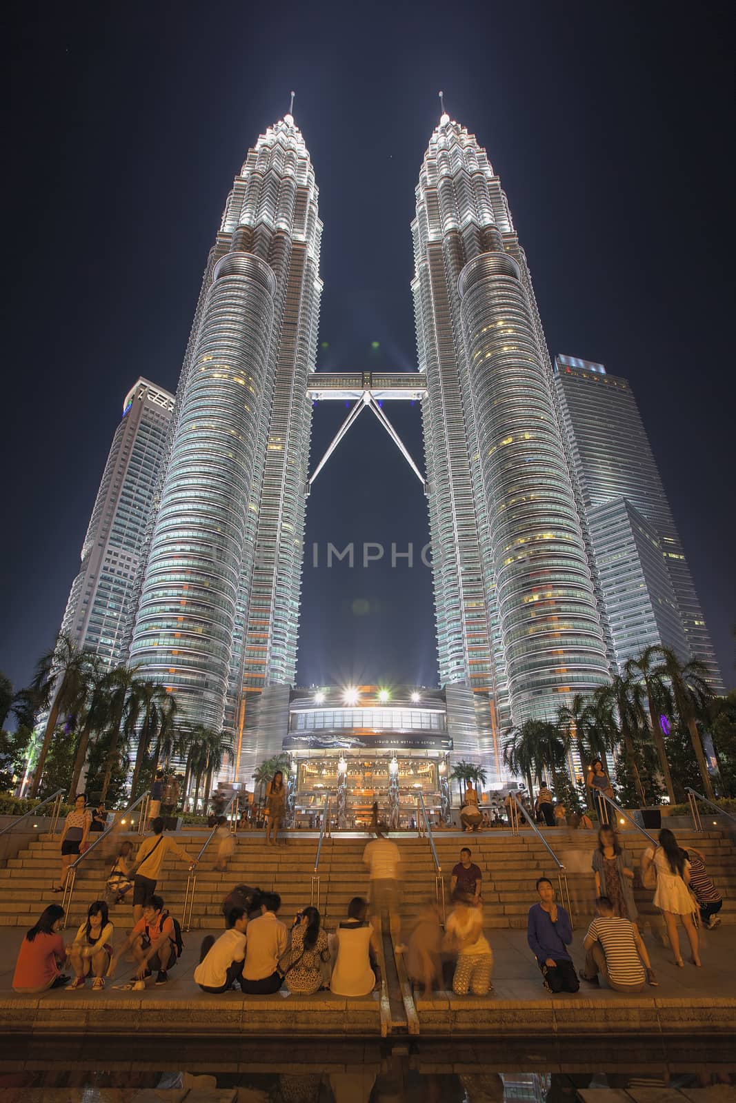 KUALA LUMPUR, MALAYSIA - FEBRUARY 3, 2014 - Tourists enjoying Petronas Twin Tower at Night. Petronas Twin Tower was the tallest buildings in the world from 1998 to 2004 until it was surpassed by Taipei 101. It remains the tallest twin towers in the world.