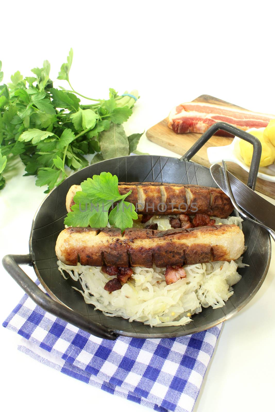 fried sausage with sourcrout by silencefoto