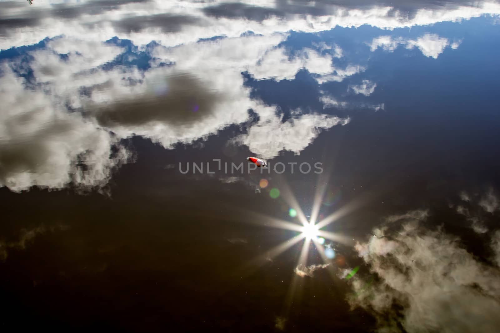 water landscape reflexin the sky and fishing bobber