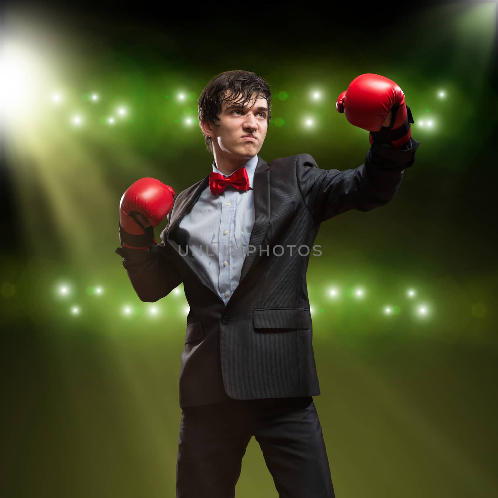 image of a businessman with boxing gloves in the ring, the competition in the business