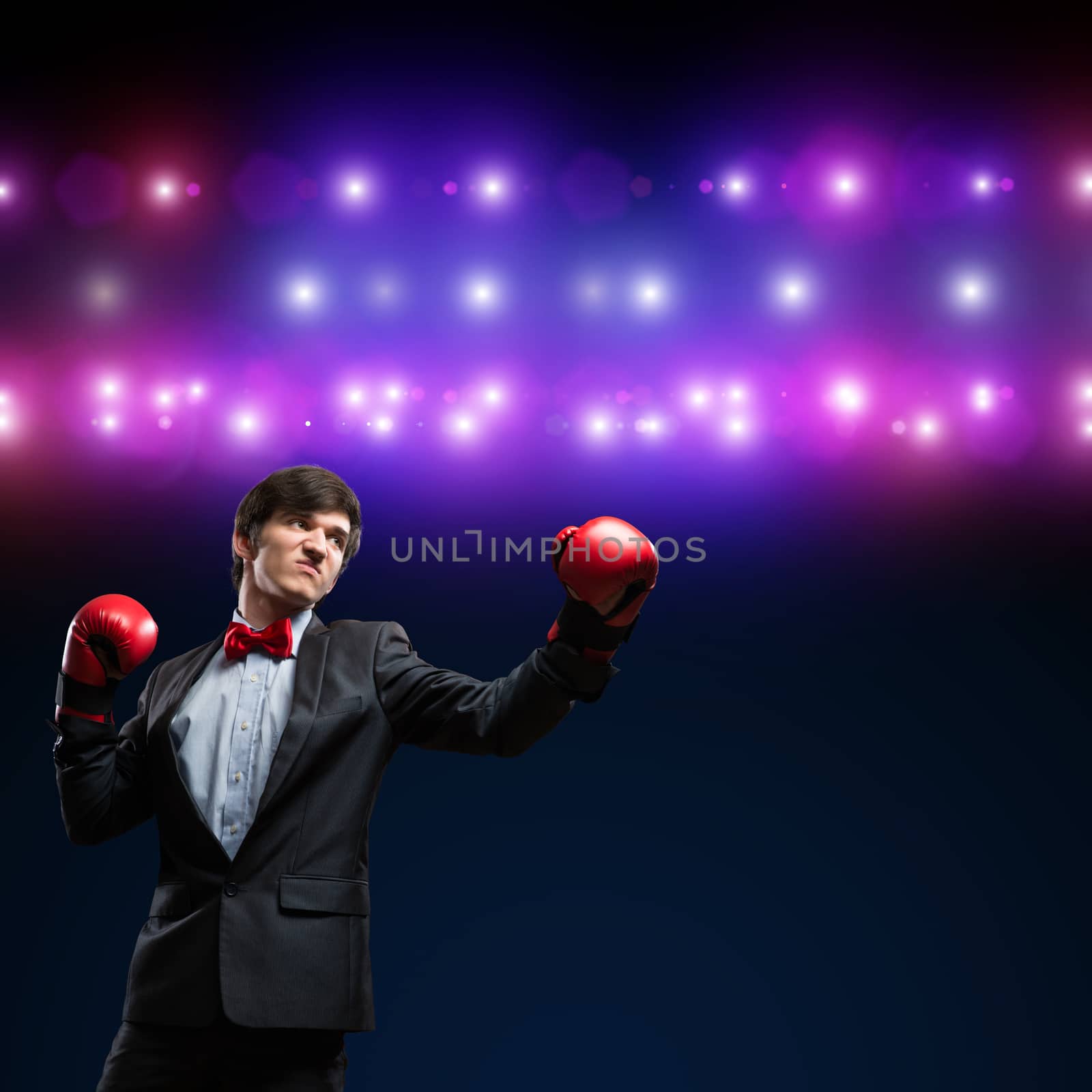 image of a businessman with boxing gloves in the ring, the competition in the business