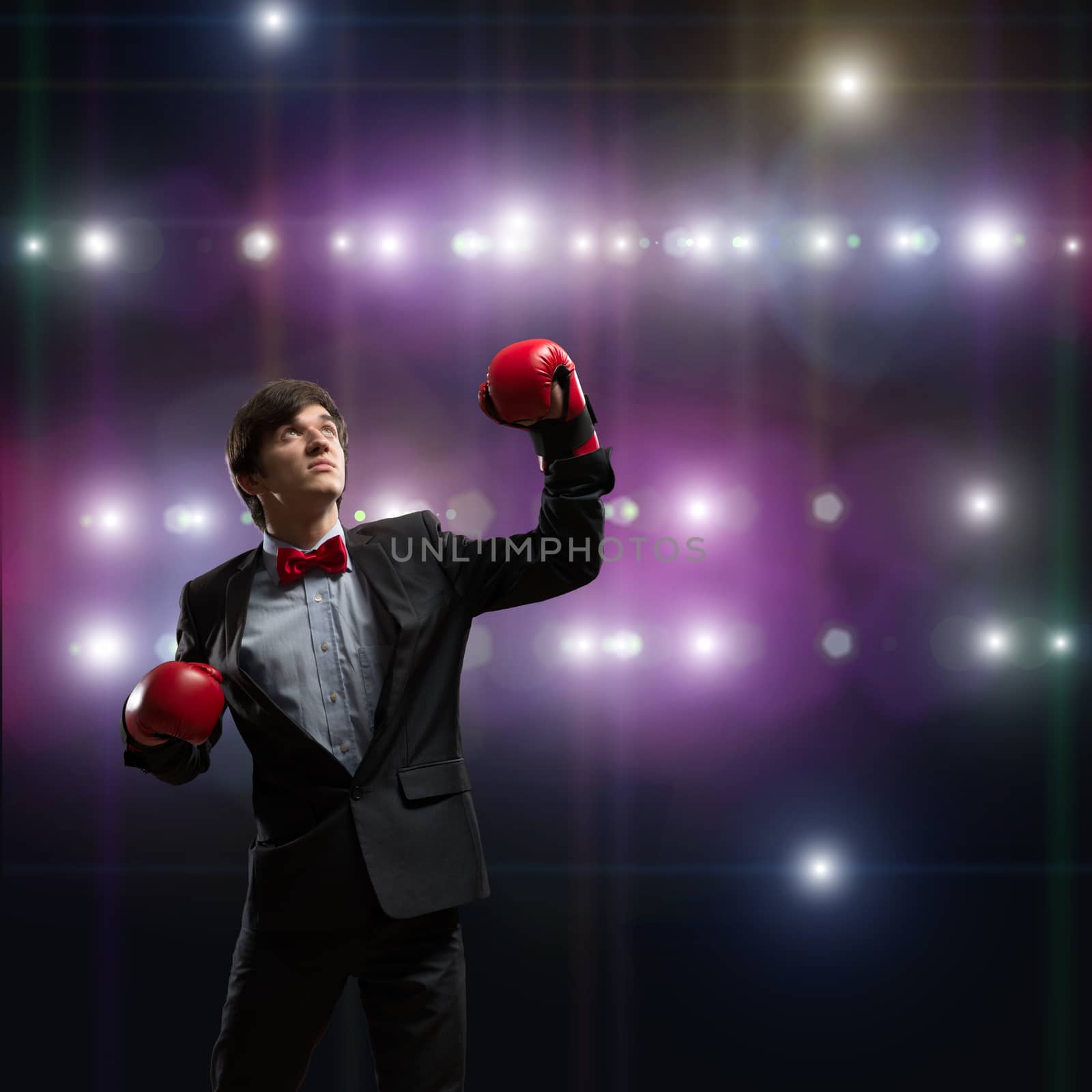 image of a businessman with boxing gloves in the ring, the competition in the business