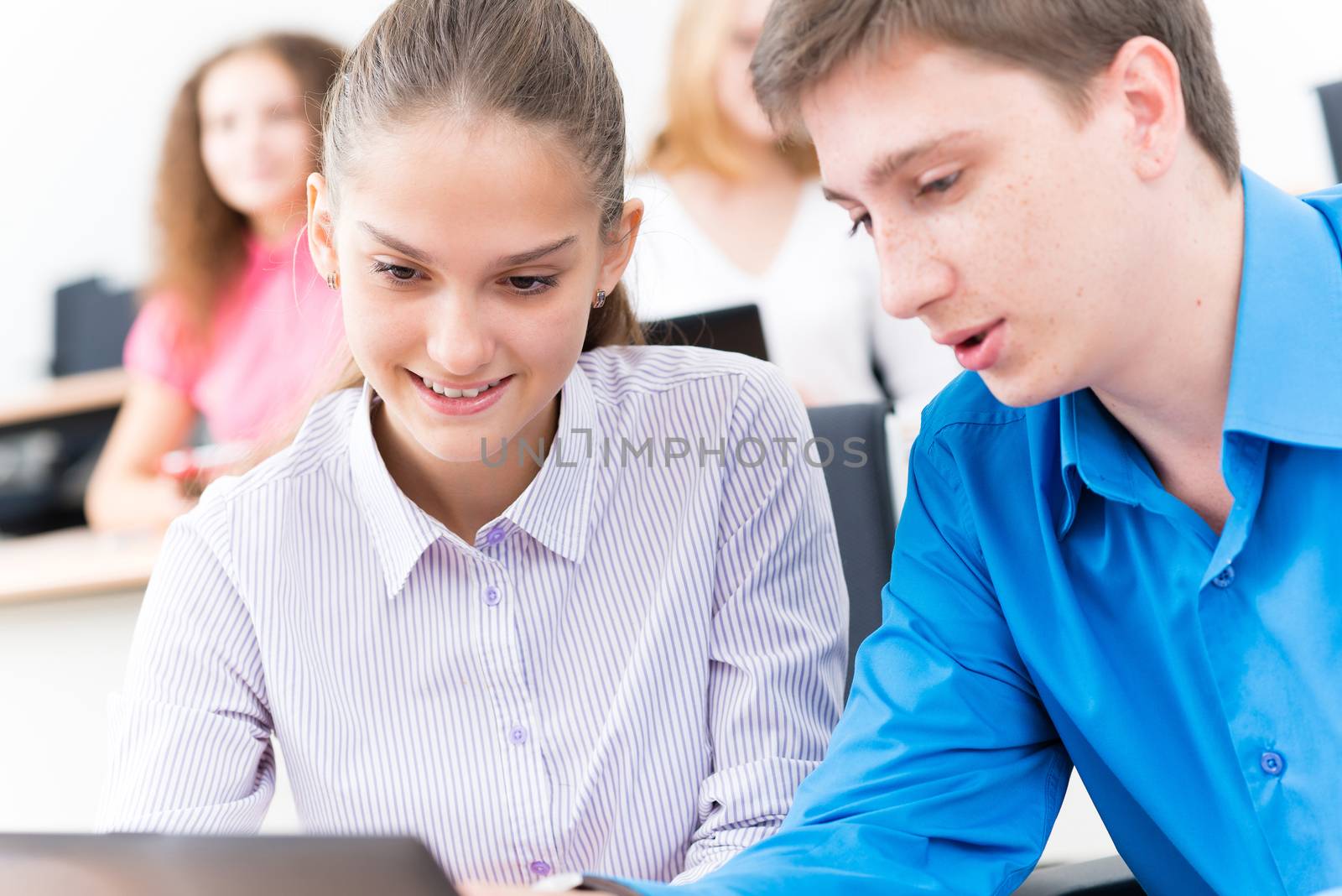 students together to discuss the lecture, come together, looking at laptop monitor