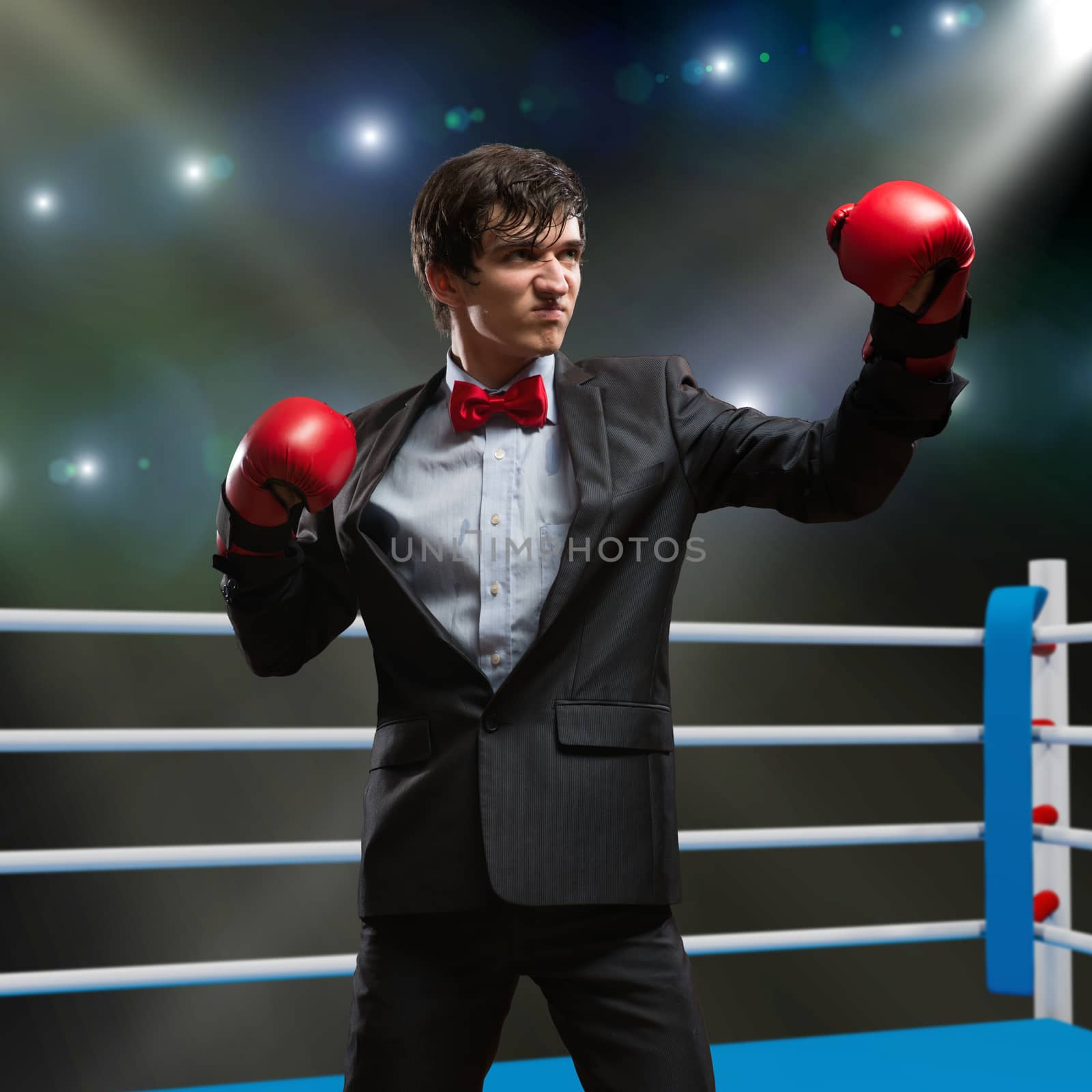 image of a businessman with boxing gloves in the ring, the competition in the business