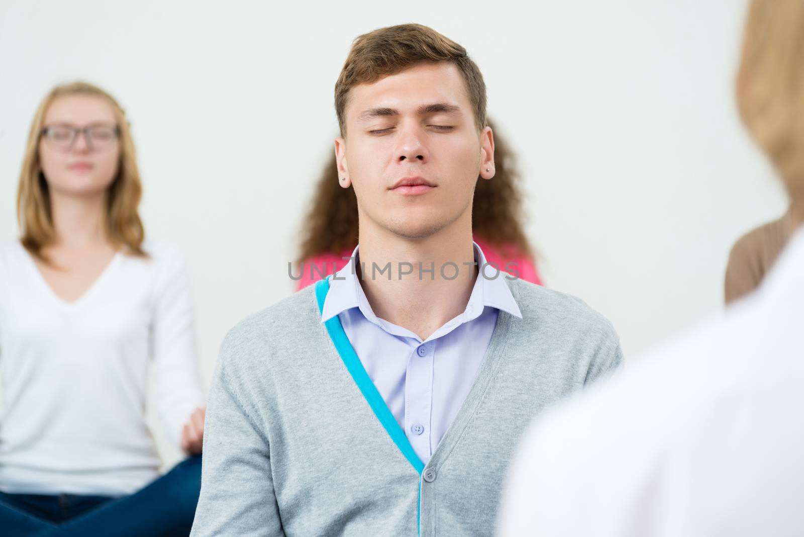 young man, meditating with closed eyes by adam121