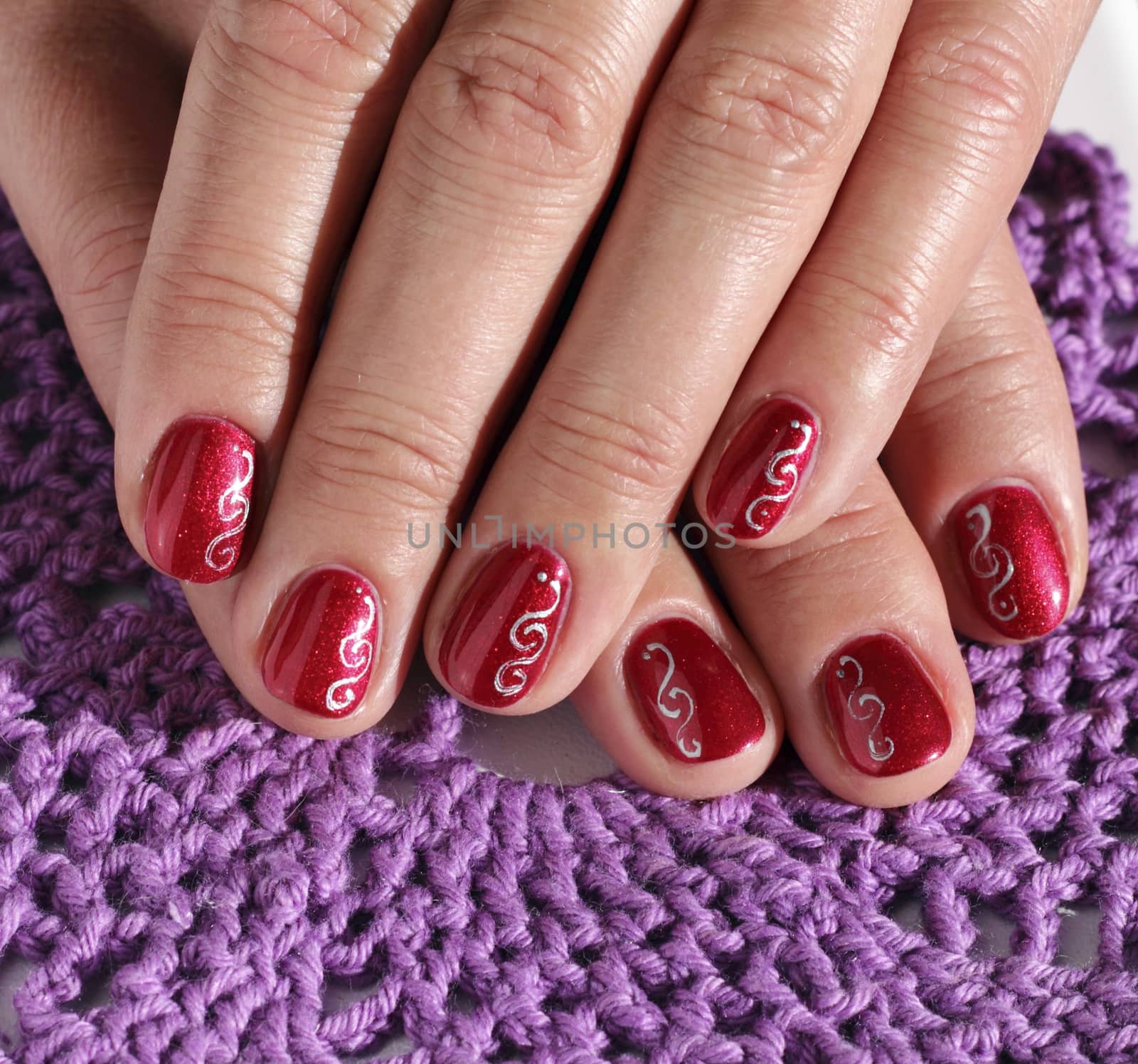 Woman fingers with decorated nails