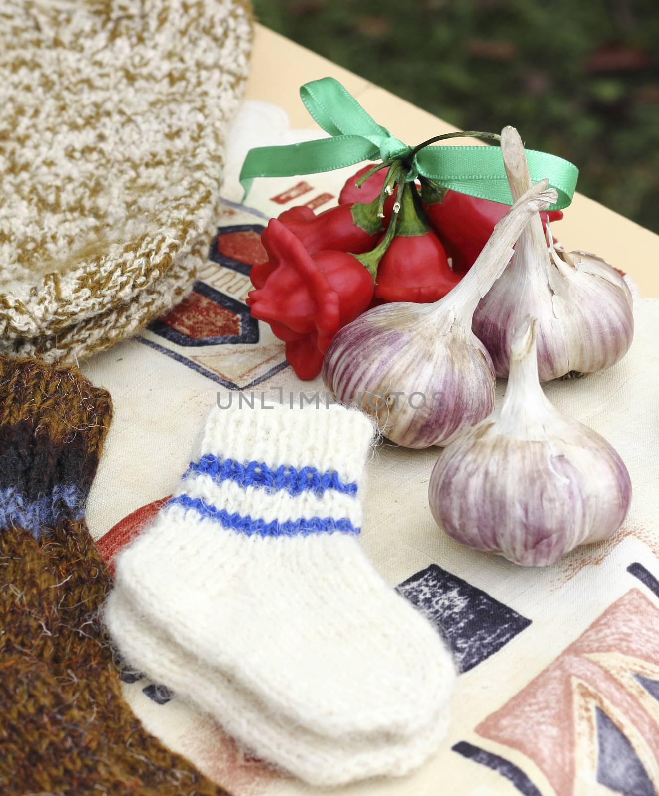 preparing for winter - woolen knitted baby socks and organic grown garlic
