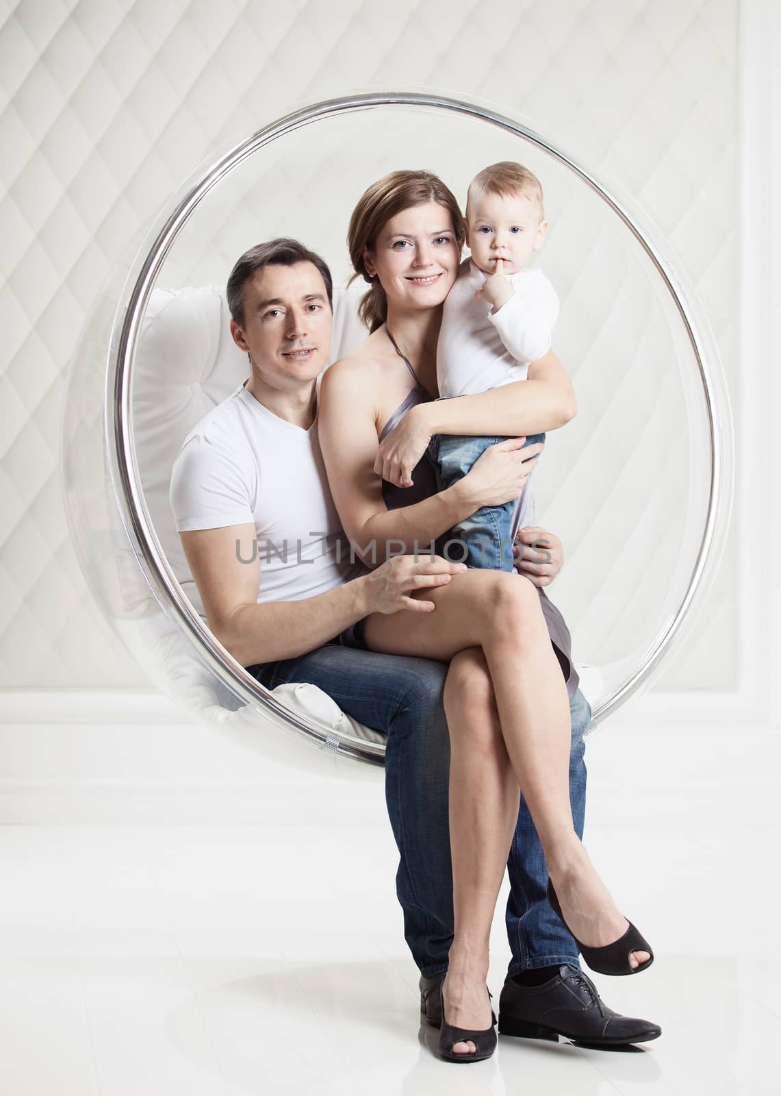 Family with baby boy on swinging hanging chair by photobac