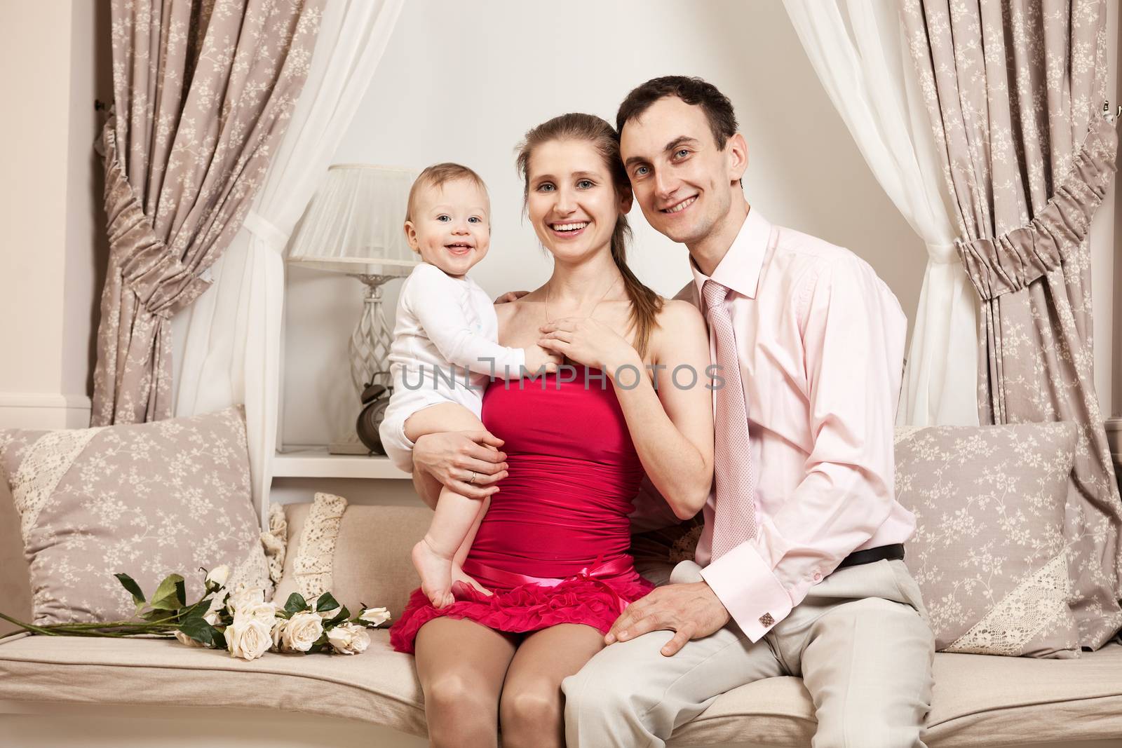 Young happy family with a baby at home