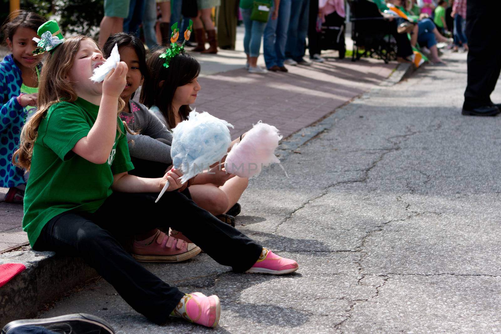 Atlanta, GA - March 15, 2014:  Kids eat cotton candy at the annual Atlanta St. Patrick's parade.