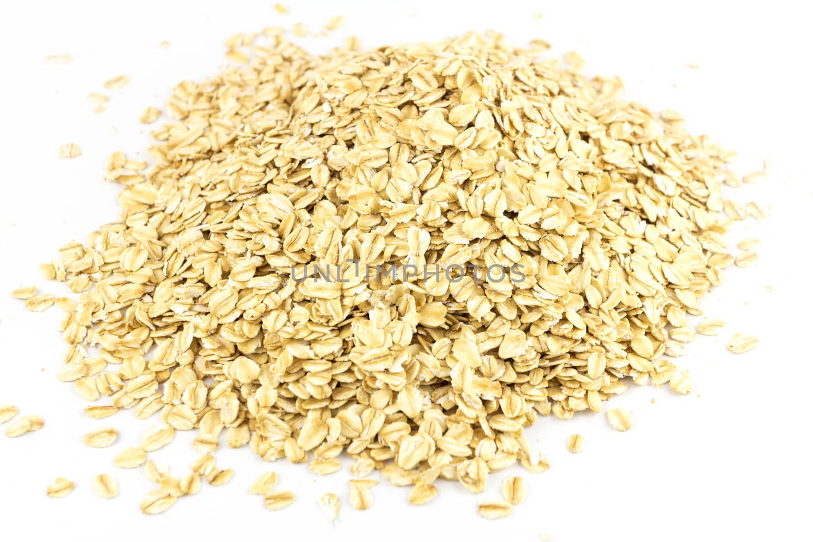 Heap of dry rolled oats isolated on white background  by wyoosumran