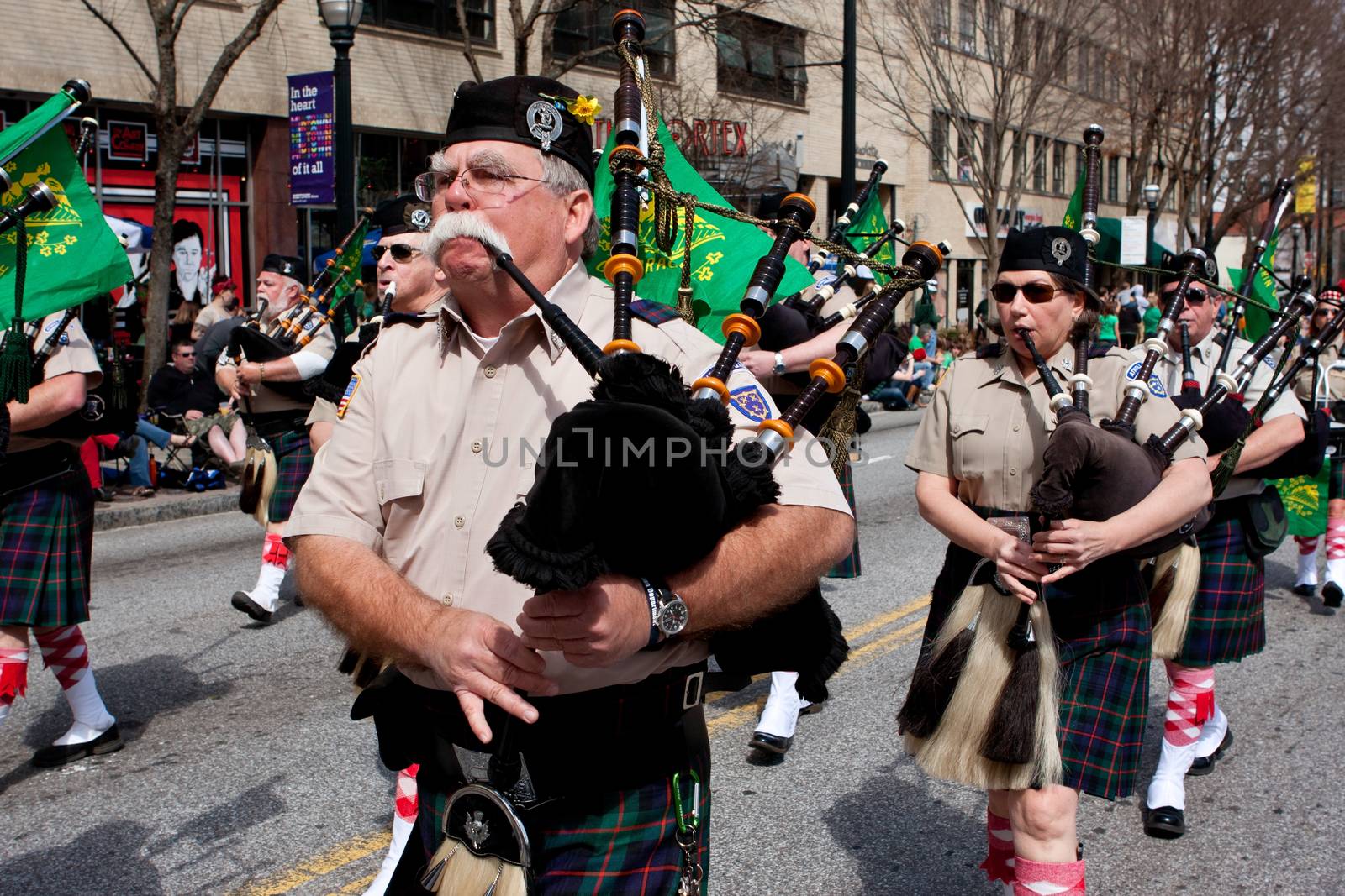 Atlanta, GA, USA - March 15, 2014:  A bagpipes corps plays the bagpipes while marching in the St. Patrick's parade on Peachtree Street.