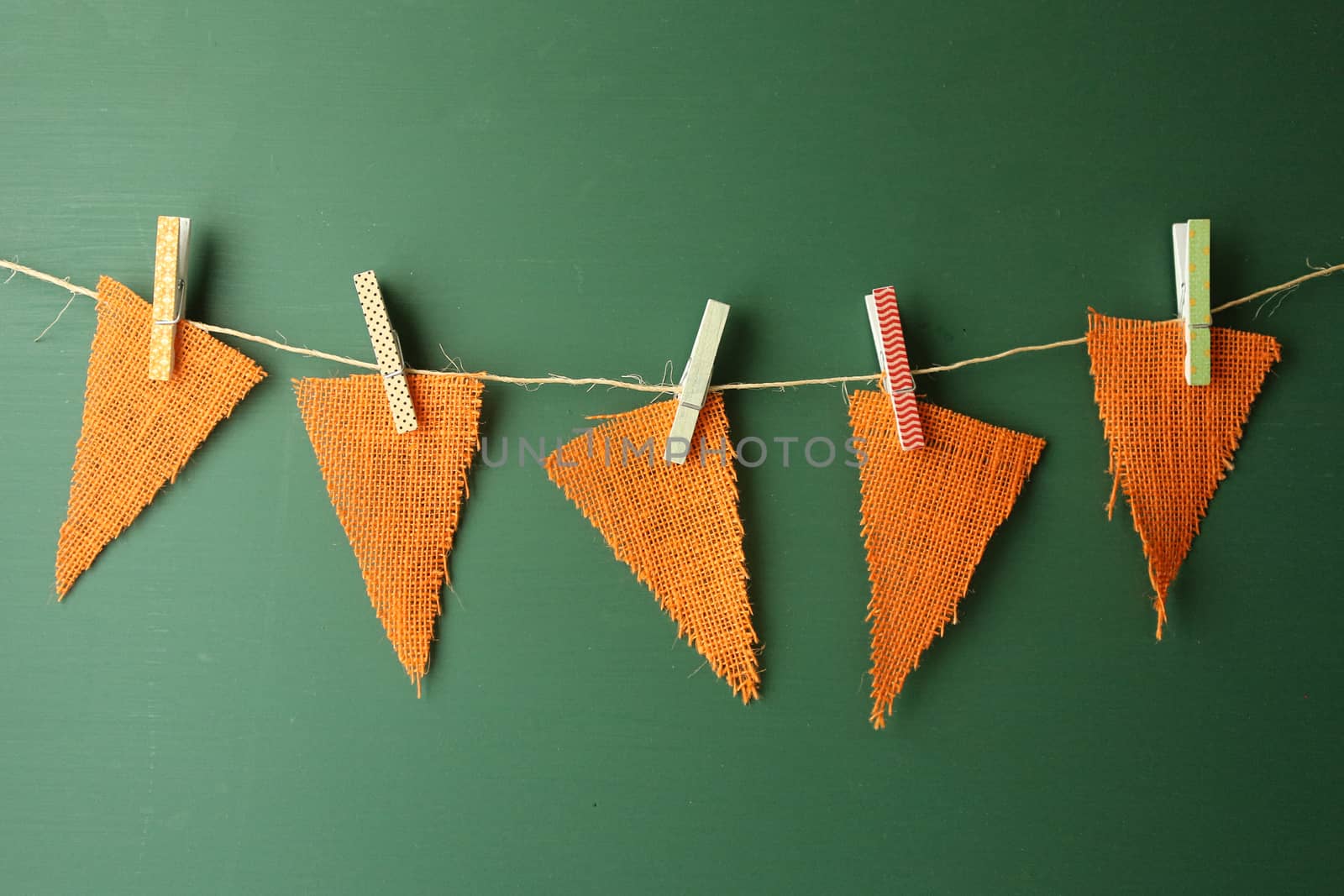 Orange Burlap Pennants Hanging on a Green Chalkboard