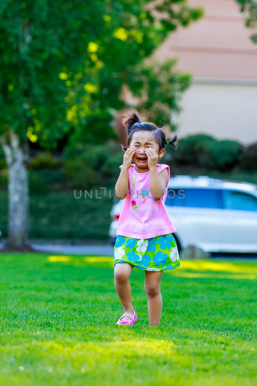 Adorable girl upset and cry in the park