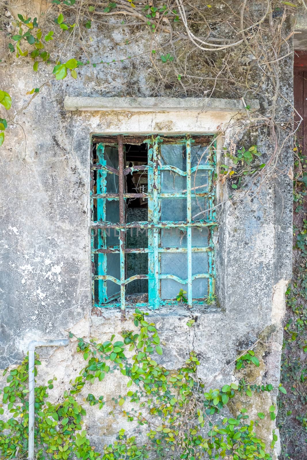 Metal window frame on a old house, nobody