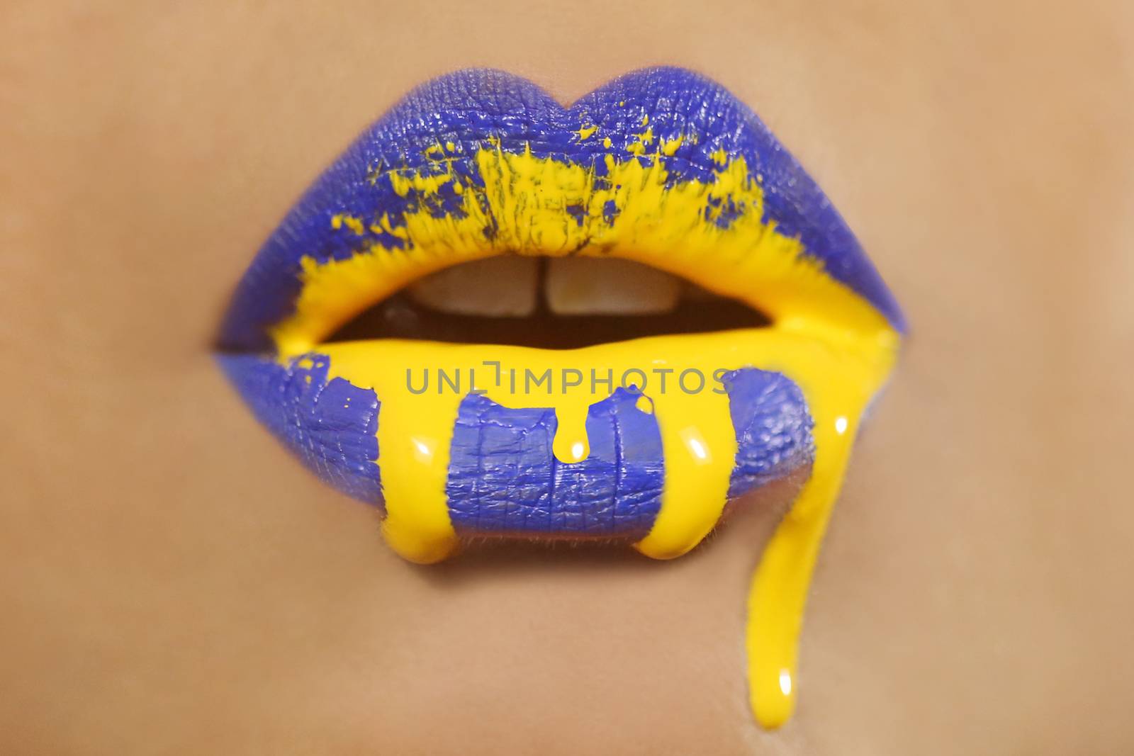 Dripping Creative Make Up on the Lips of a Fashion Model