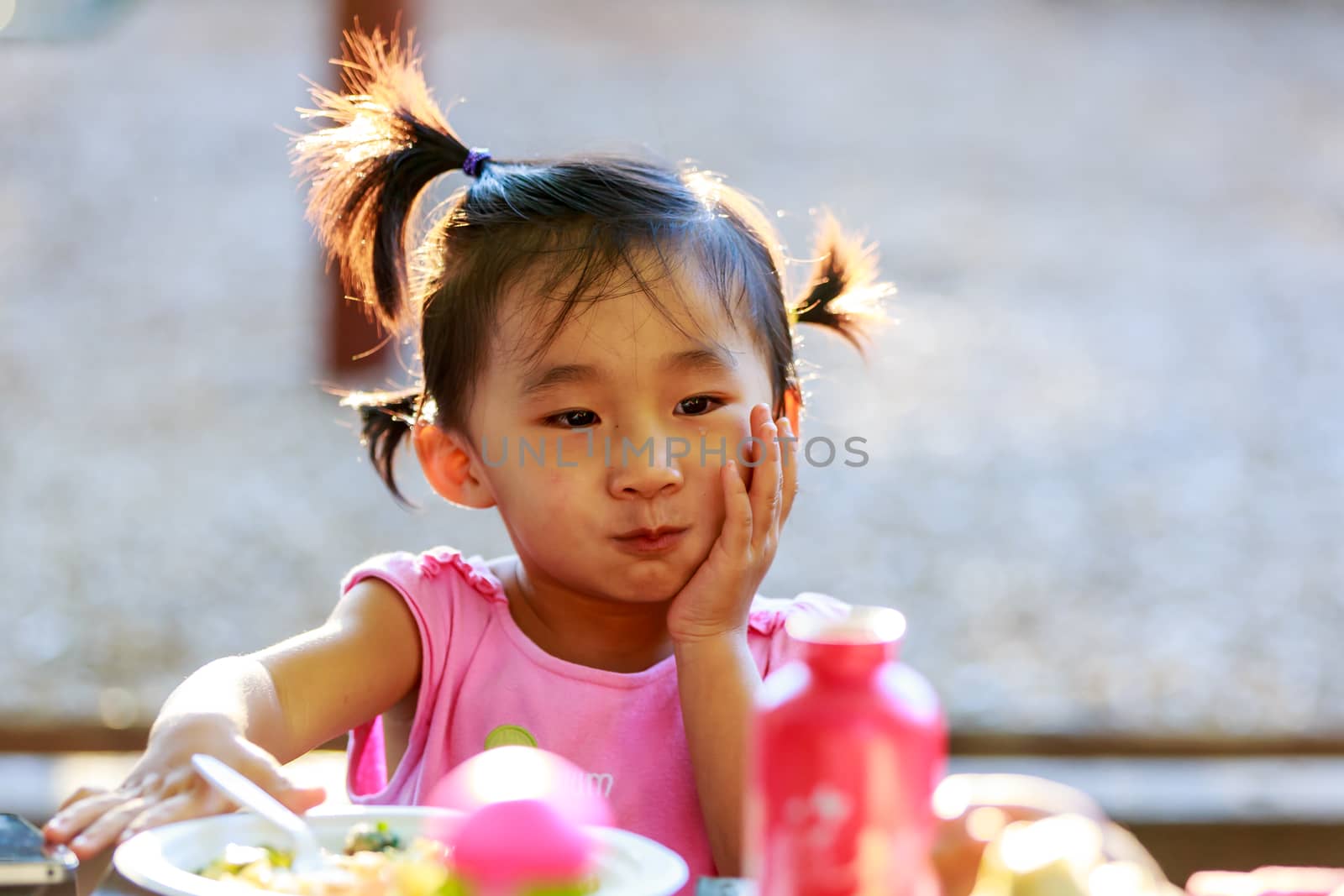 Adorable girl making faces in the park