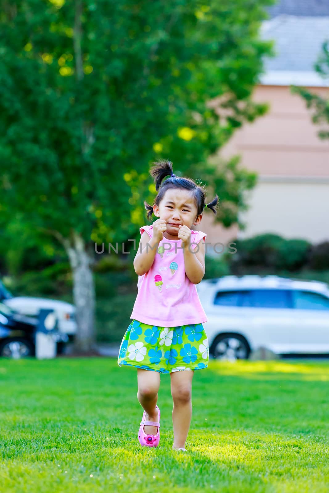 Adorable girl upset and cry in the park