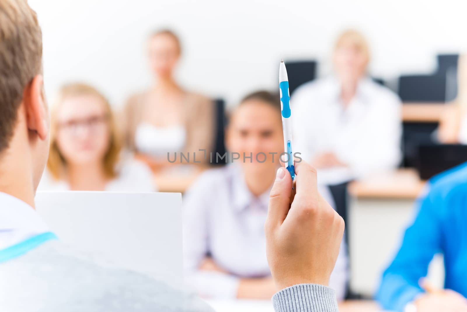 close-up of hands of a teacher with a ballpoint pen, the teacher focuses attention on himself gesture