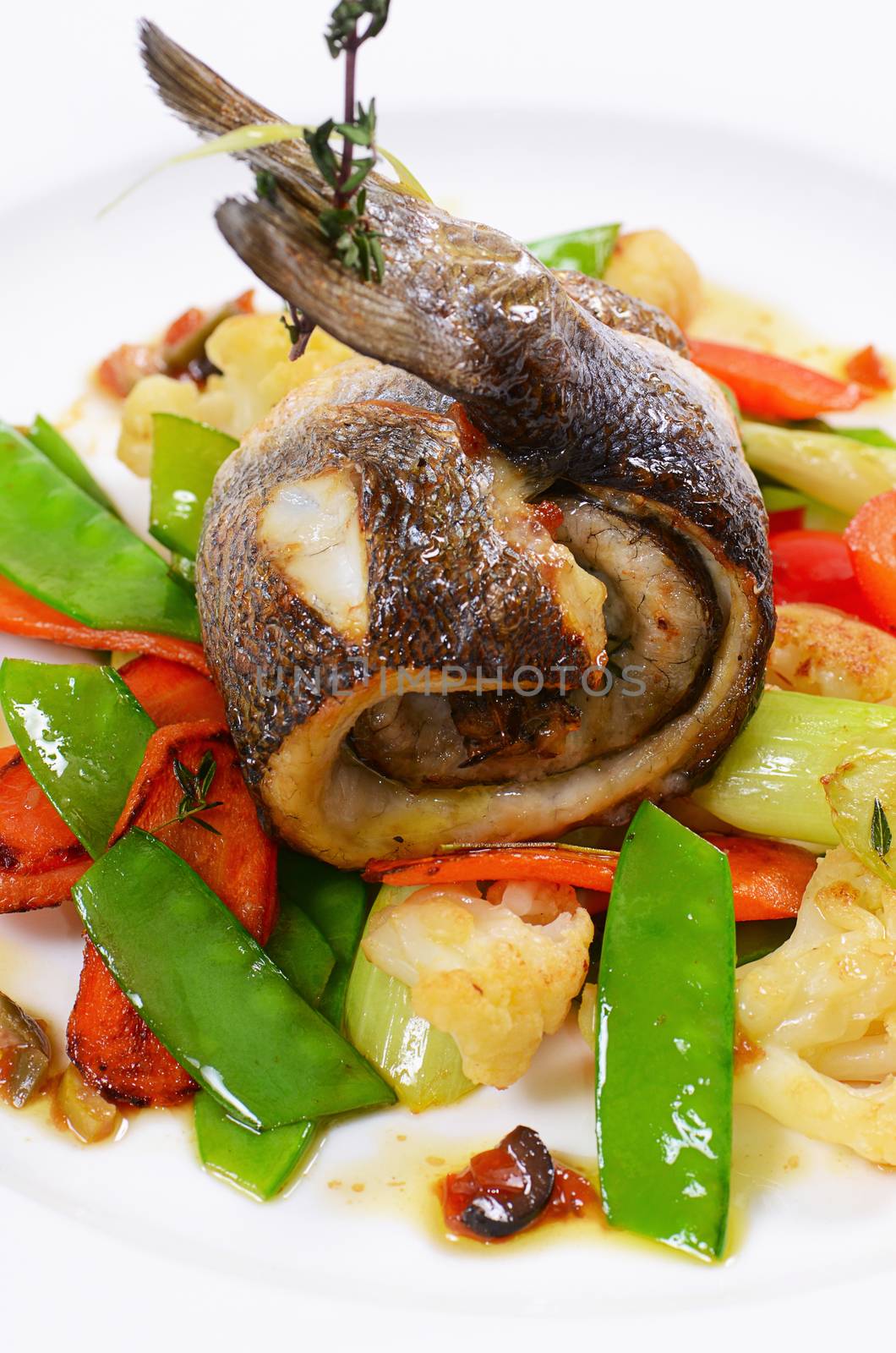 Sea bass fillet with vegetables and sauce