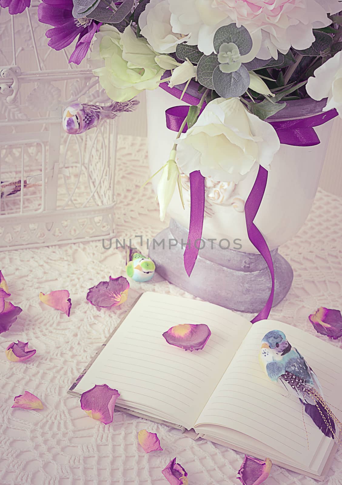 The book on a table with rose petals by SvetaVo