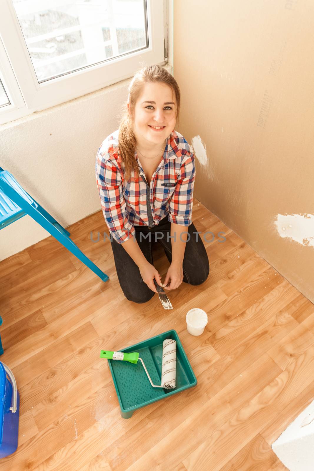 smiling woman doing renovation by Kryzhov