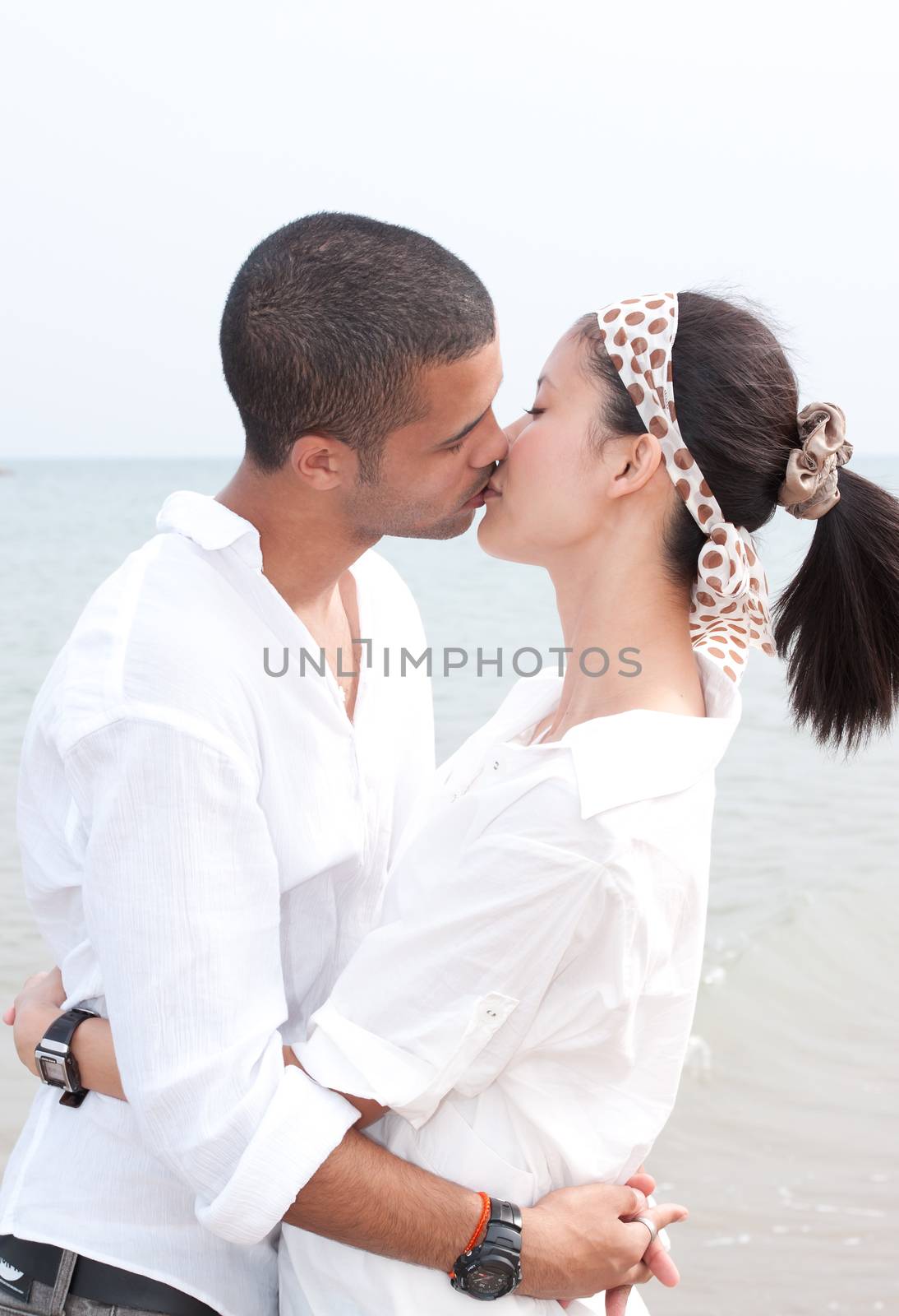 african man and asian woman lover on the beach